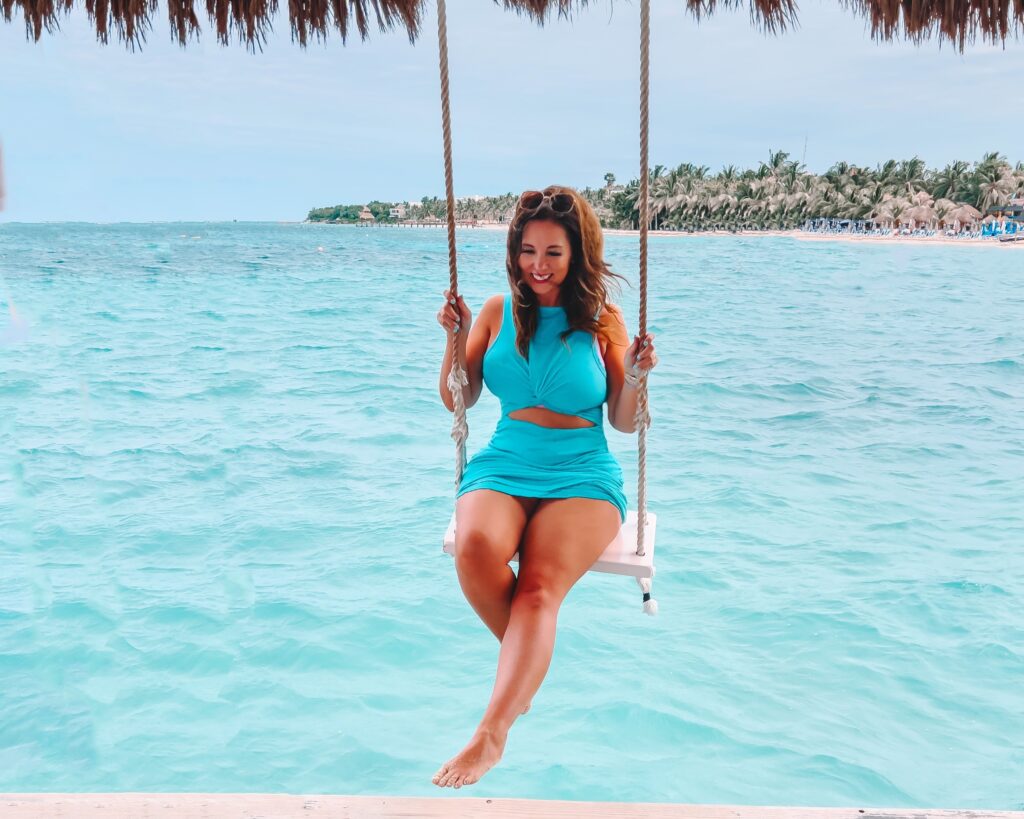 Melissa Newman swinging over the ocean at Paradise Beach in Cozumel, Mexico