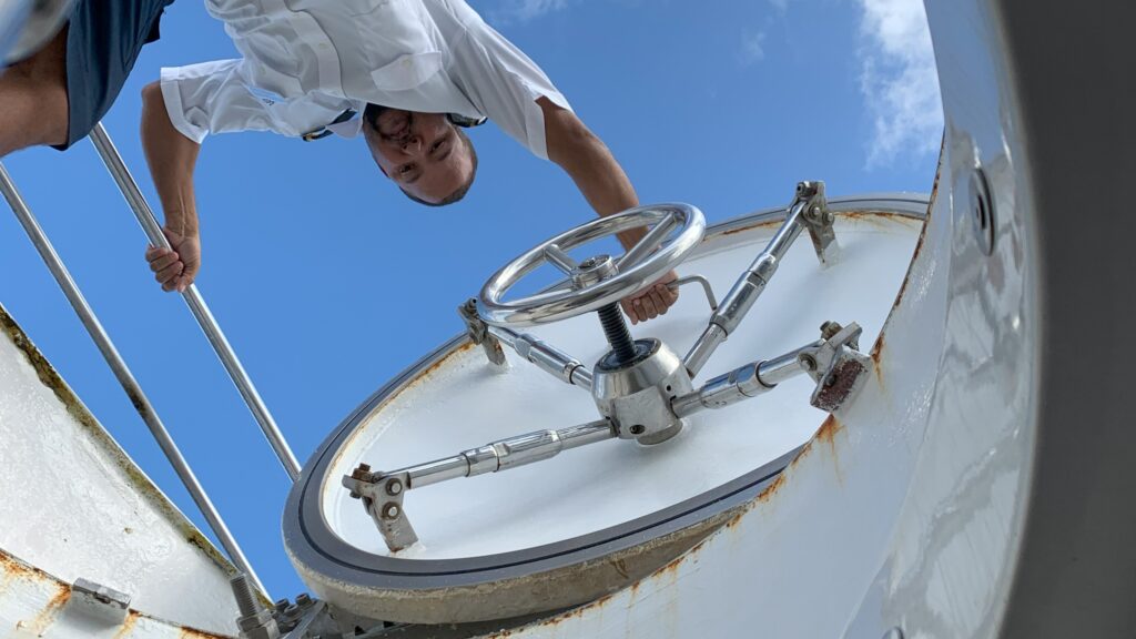 An employee opens the submarine hatch.