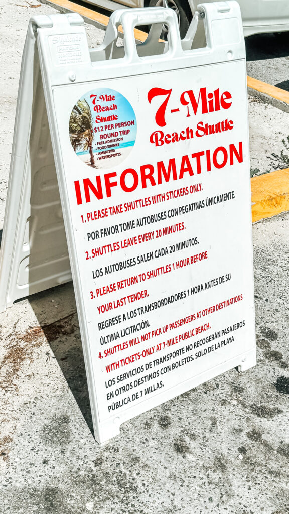 A sign in a parking lot at Seven Mile Beach in Grand Cayman explains the process for taking a taxi back to the cruise port