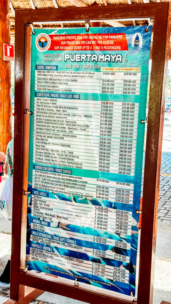 A sign displaying taxi prices at the Puerta Maya cruise pier in Cozumel, Mexico