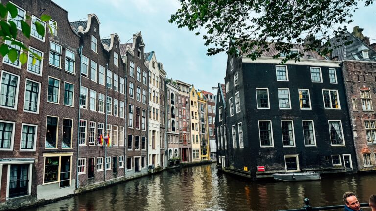 Historic buildings in Amsterdam, Netherlands within a canal.