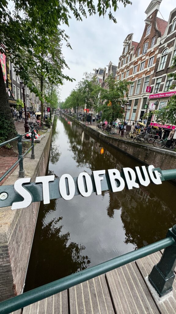 A "Stoofbrug" sign over a canal in Amsterdam's Red Light District. 