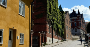 A close-up view of a cobblestone street in Visby, showcasing colorful historic buildings.